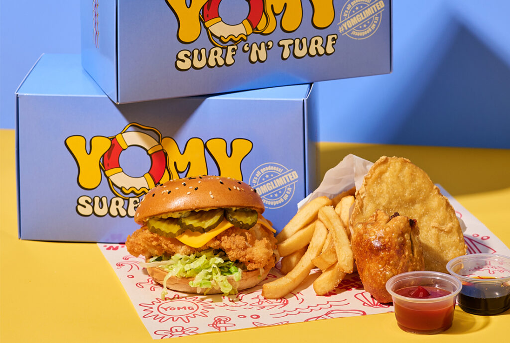 Surf 'n' Turf Box from YOMG ~ Fish Royale Burger (golden crumbed fresh fish, cheese, shredded iceberg lettuce, bread and butter pickles, secret sauce), fried south melbourne dim sim, potato cake, fat chips, with a side of ketchup and soy sauce