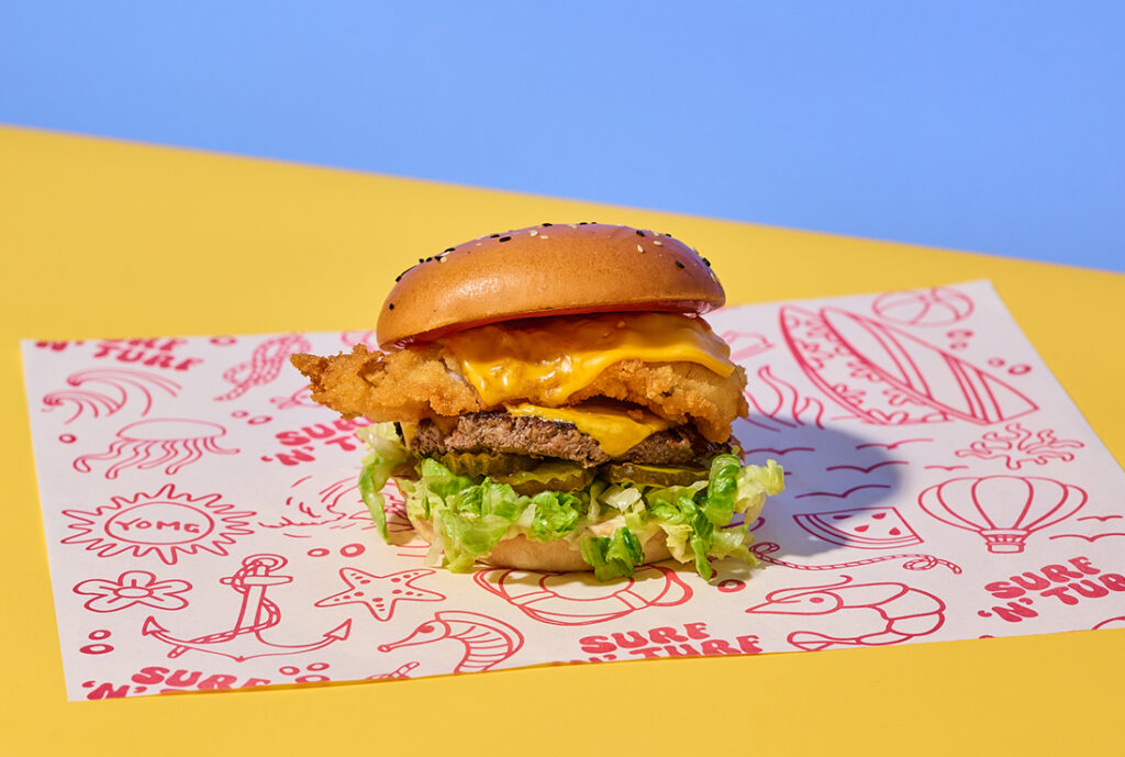 Surf 'n' Turf Yo My Burger from YOMG ~ beef, golden crumbed fresh fish, double cheese, shredded iceberg lettuce, bread and butter pickles, secret sauce, ketchup