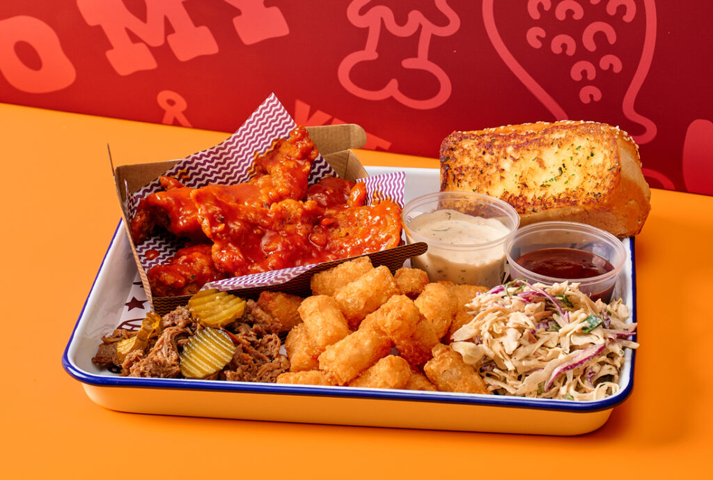 Cookout Box #YOMGLimited Box Meal by YOMG ~ hot buffalo crunch chick'n strips (3 pce), dr. pepper® braised pulled beef brisket, texas toast, buttermilk ranch slaw, tater tots, bread & butter pickles, with a choice of two dipping sauces