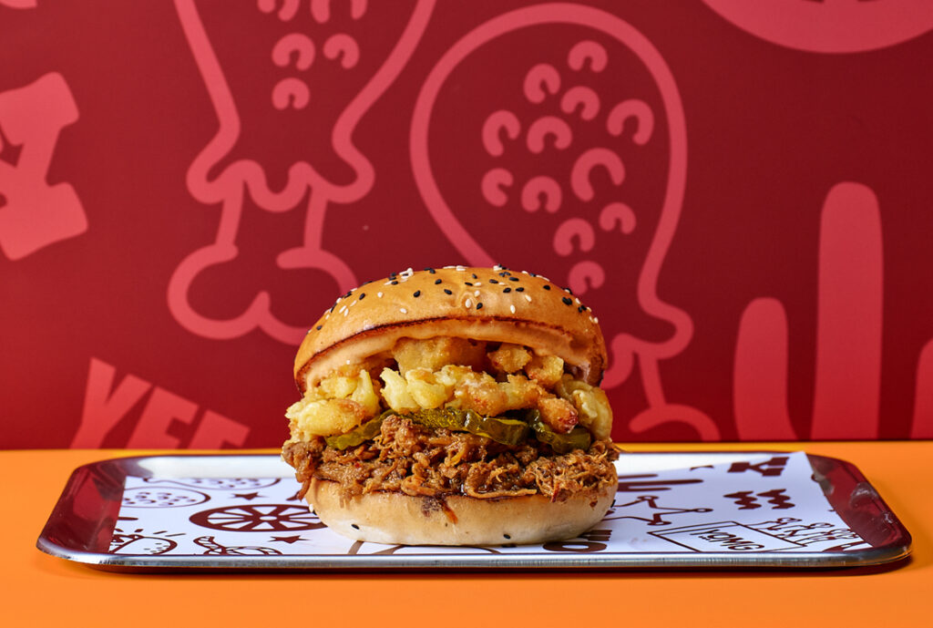 The Pitmaster #YOMGlimited Burger by YOMG ~ dr. pepper® braised pulled beef brisket, smashed mac & cheese bites, bread & butter pickles, hometown mayo, texan BBQ