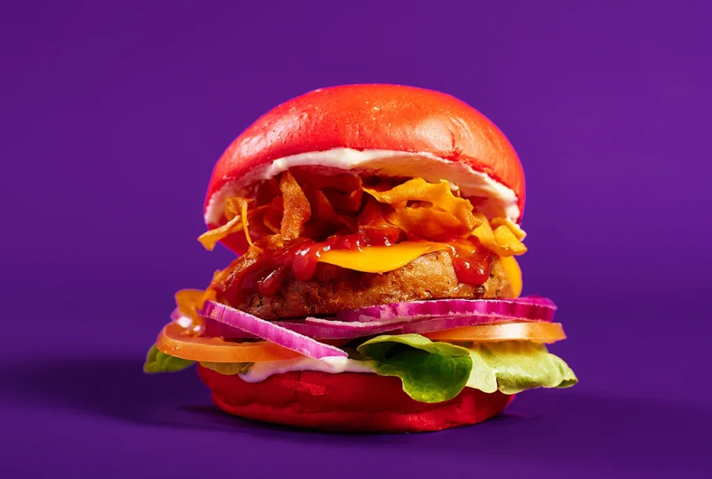 YOMG Miss Fu Vegetable Fritter Vegan Burger Menu Item - vegetable fritter, vegan cheese, lettuce, tomato, onion, crispy sweet potato, ketchup, tofu mayo