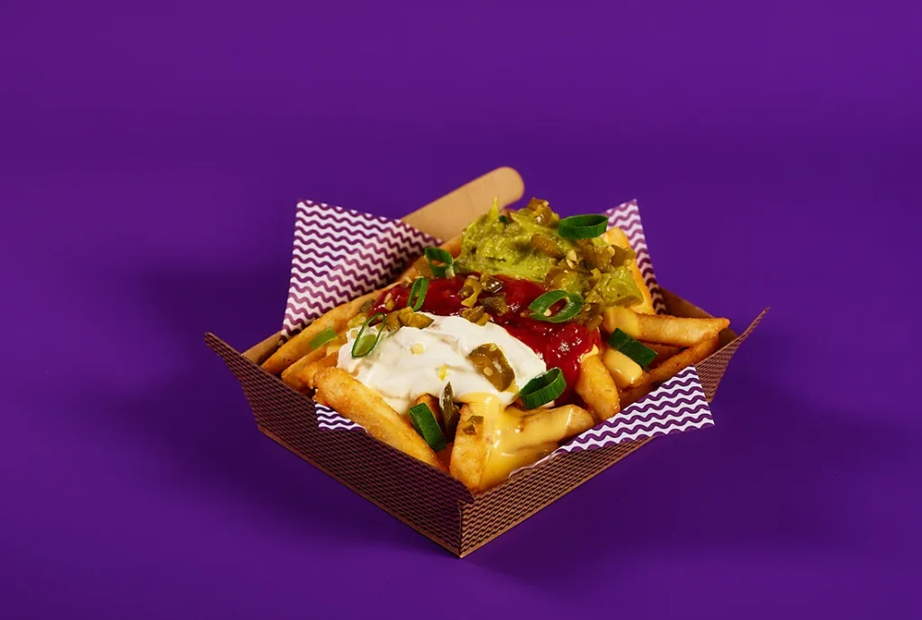 YOMG Nacho Loaded Vegetarian Fries Menu Item - cheese sauce, sour cream, guacamole, salsa, jalapenos, spring onion