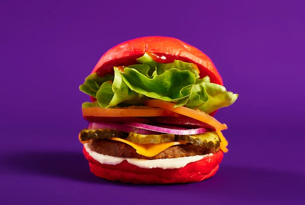 YOMG The Vegan Hustle Vegan Burger Menu Item - plantein, vegan cheese, lettuce, tomato, beetroot, onion, pickles, ketchup, tofu mayo